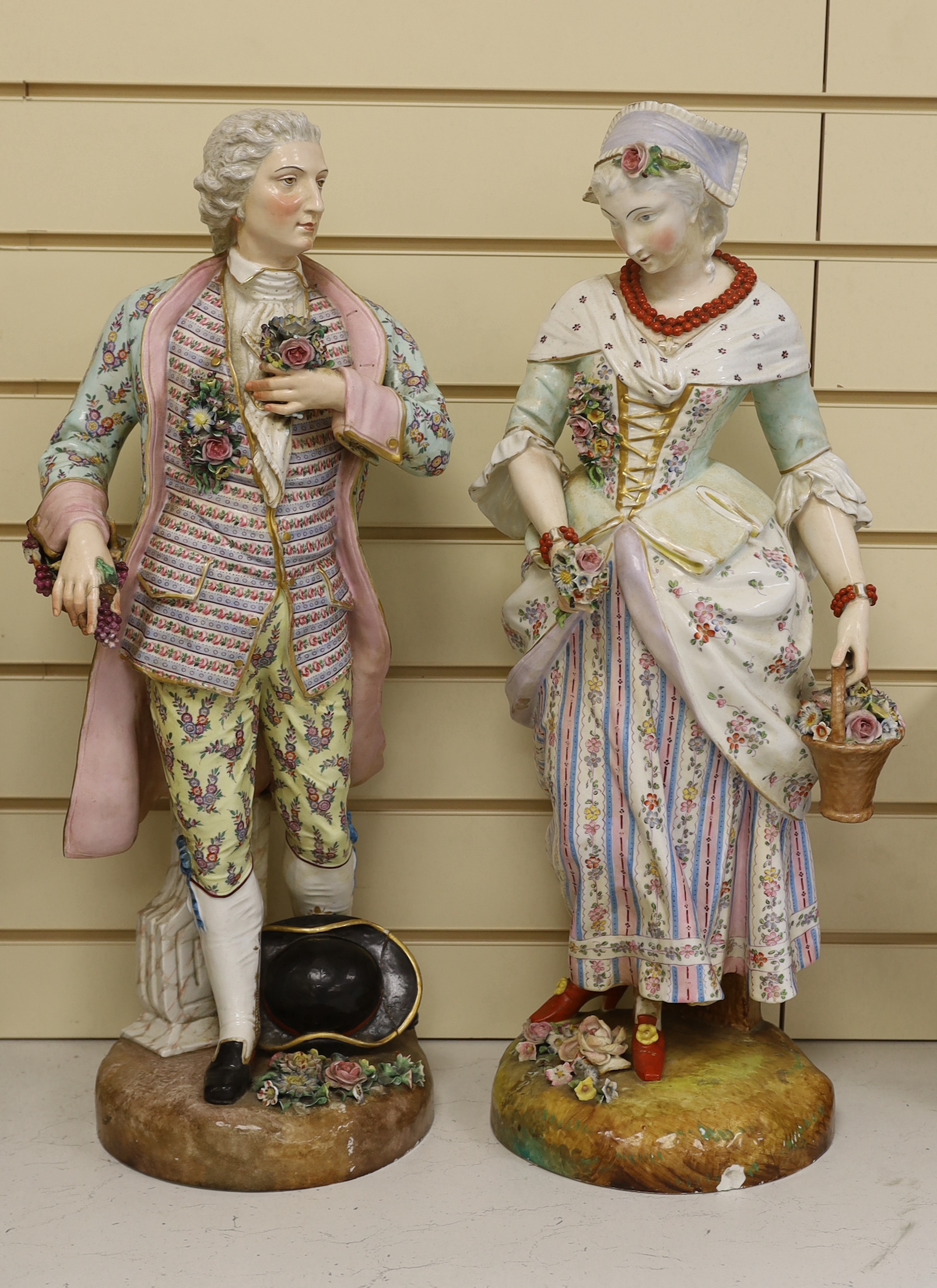 A pair of massive German porcelain figures of flower sellers, late 19th century, 66.5cm